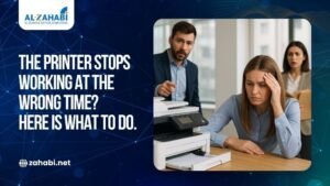 An office team in Kuwait looking frustrated around a malfunctioning office printer, representing business downtime. Featuring the Al-Zahabi logo and a call to action: "The printer stops working at the wrong time? Here is what to do."