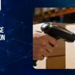 Handheld barcode scanner scanning a barcode label on a cardboard box, illustrating warehouse automation solutions for the FMCG industry through automated inventory tracking.